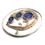 A Danish Art Nouveau oval brooch, with rub over border on mother of pearl backing shell, set with th