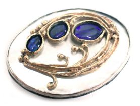 A Danish Art Nouveau oval brooch, with rub over border on mother of pearl backing shell, set with th