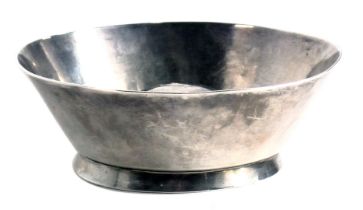 A white metal wine taster, with convex base and plain foot marked with a series of 'x' motifs, unmar