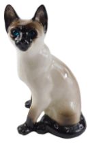 A Winstanley ceramic cat, with blue glass eyes, 34cm high.
