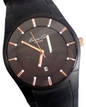 A Kenneth Cole gentleman's wristwatch, in stainless steel back and blackened face, with gold coloure