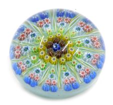 A millefiori paperweight, decorated in blue, red, green, yellow, etc., possibly Scottish, 7cm diamet