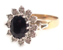 A 9ct gold cluster ring, centred by oval sapphire in claw setting, with outer petals each with illus