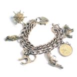 A 9ct gold two bar charm bracelet, with heart shaped padlock and assortment of charms, the bracelet