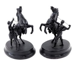 A pair of reproduction spelter marley horse type figures, each with rider on an oval hollow base, 22