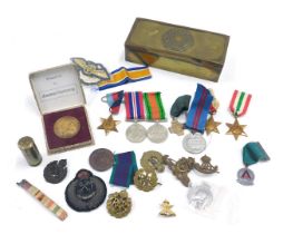 A quantity of cap badges, WWII medals, etc., two ATA cloth badges, a City of Peterborough cloth badg