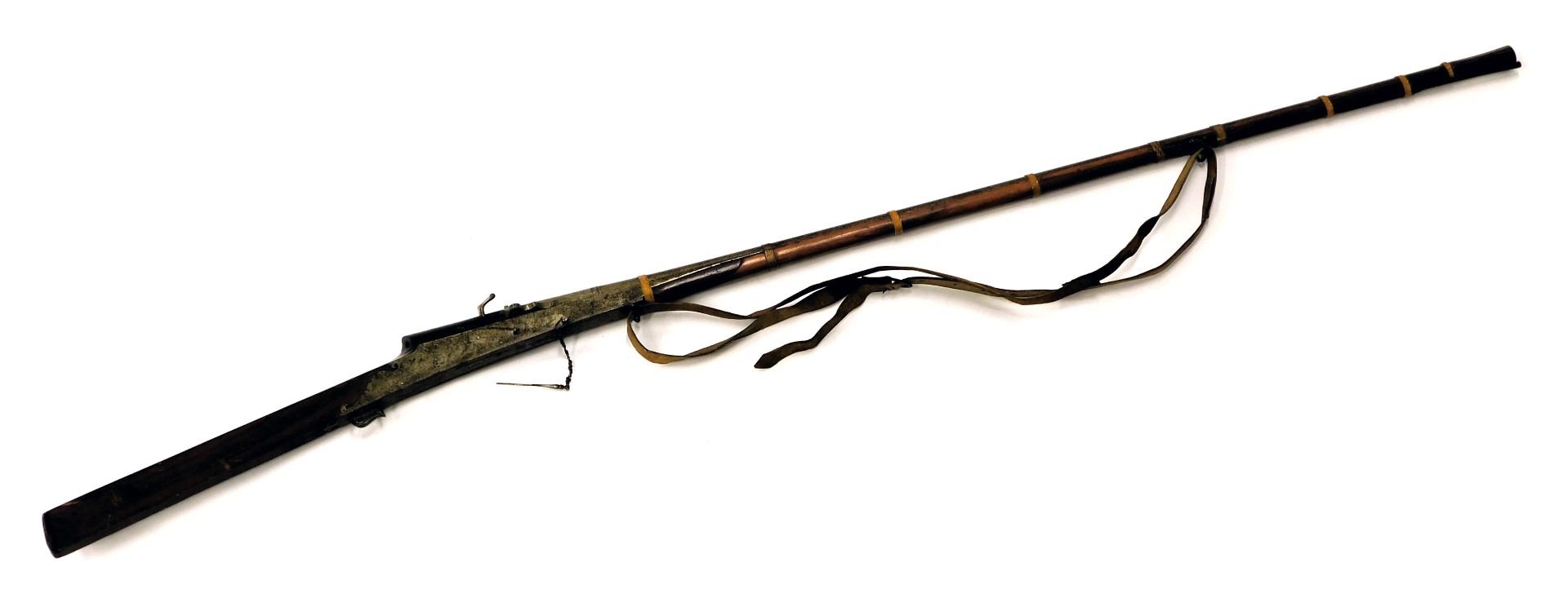 A 19thC Indian matchlock musket, with slightly flared muzzle, ram rod and leather sling, the barrel