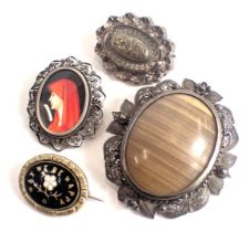 Four various brooches, comprising a Victorian oval silver brooch, 3cm wide, a tiger's eye and white