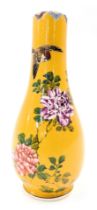 A late 19th/early 20thC Japanese earthenware bottle shape vase, decorated with coloured flowers on a