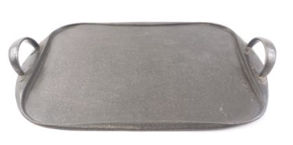 An Arts and Crafts Tudric pewter rectangular two handled tray, with hammered decoration, 47cm wide.