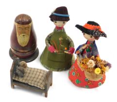 A small set of Russian dolls, the largest being Father Christmas, 9cm high, two costume dolls, and a