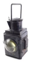 A British Rail black painted metal lamp, with two large convex lenses, 45cm high.