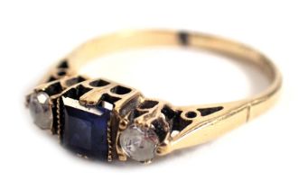 A 9ct gold Art Deco style dress ring, set with central sapphire and flanked by two CZ stones, in a r