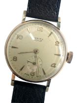 A 9ct gold Vertex Revue wristwatch, with a cream coloured numeric dial and seconds dial, brown leath