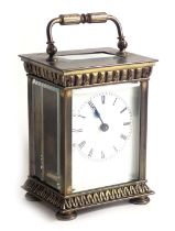 A French brass carriage clock, with enamel dial, the case with columns and cast with leaves, 14cm hi