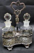 A Victorian silver plated two bottle cruet stand, containing a pair of cut glass bottles with facete