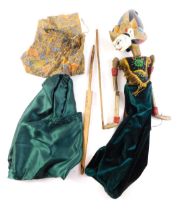 An Eastern dancing puppet, with painted wooden head, the body embellished with sequins, gold coloure