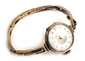A 9ct gold wristwatch, with a silvered numeric dial and seconds dial, with black hands, on an expand