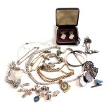 A group of assorted costume jewellery, to include silver charm bracelet, cap badges, dress ring, but
