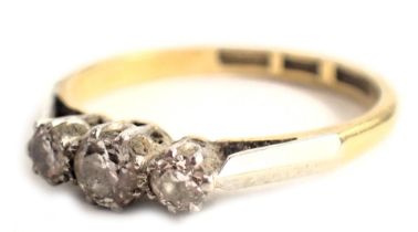 A diamond three stone dress ring, set with three round brilliant cut diamonds, the central stone app