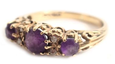 A 9ct gold amethyst set gypsy ring, set with three oval graduated amethysts and four tiny diamonds,