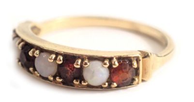 A 9ct gold half hoop dress ring, set with four garnets and three opals, each in claw setting, ring s