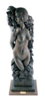 A carved wooden sculpture, of a semi-clad female in leaf vine wrap, on a stepped base, 67cm high.