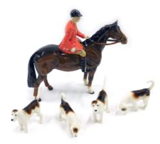 A Beswick part hunting set, comprising huntsman on brown horse and four hands.