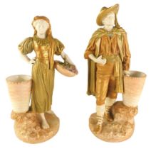 A pair of Royal Worcester porcelain blush ivory ground male and female figures, each standing beside