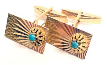 A pair of cufflinks, each with rectangular face and star etched design, set with turquoise, yellow m