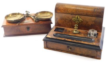 A Victorian burr walnut and ebonised desk stand, with single brass candlestick associated inkwell et