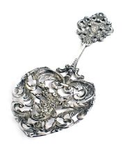 A Victorian silver heart shaped pierced spoon, decorated with scrolls, masks, etc., London 1890 by W