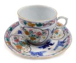 A Japanese porcelain cup and saucer, painted with flowers and with underglaze blue decoration.