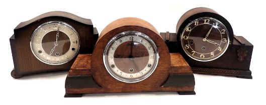 Three mantel clocks, comprising two oak cased and one walnut, a 1950s example in domed case, two Ben