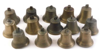 A collection of brass bells, some numbered.