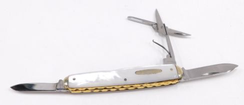 A mother of pearl and brass inlaid pen knife.