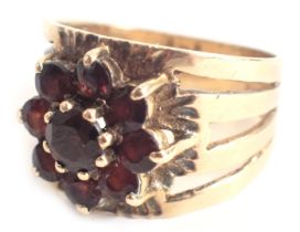 A garnet cluster ring, the garnet cluster in claw setting, with hammered and etched design ring head