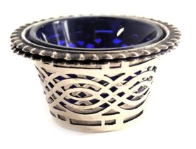 A small silver salt, with pierced sides and blue glass liner, 0.3oz.