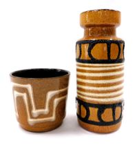 A German Fat Lava vase, decorated with geometric design in black and cream on a brown mottled ground