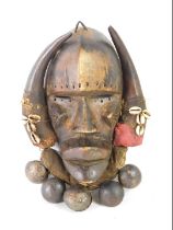 An African Tribal Dan Kran warrior's mask, with fabric border applied with shells and bells, Cote D'