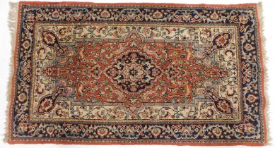 A Turkish red ground rug, 89cm x 158cm.