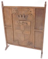 An oak fire screen, decorated with a crest and initials R, 69cm wide, and a pine box. (2)