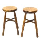 A pair of turned beech workshop stools, 46cm high.