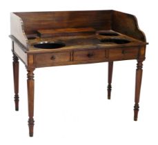 An early 19thC mahogany washstand, in the manner of Gillows, the raised back and recesses for bowls,