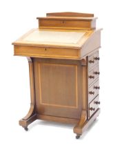 An Edwardian mahogany and satinwood banded Davenport, the raised top with a hinged recess for pens,