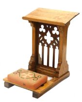 A late 19th/early 20thC oak prayer stand, with pierced gothic style panel, shaped supports, and wool