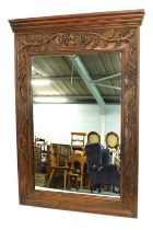 A continental hardwood wall mirror, the frame carved with grapes, vines, etc., 130cm high, 91cm wide