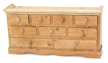 A small pine tabletop chest, of eight drawers, 34cm high, 67cm wide.