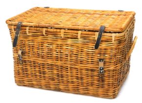 A large wicker laundry basket, with hinged lid and side handles, 95cm wide.