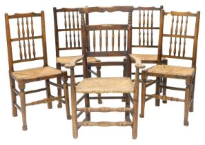 A set of four 19thC style beech country made spindle back chairs, each with turned legs and stretche